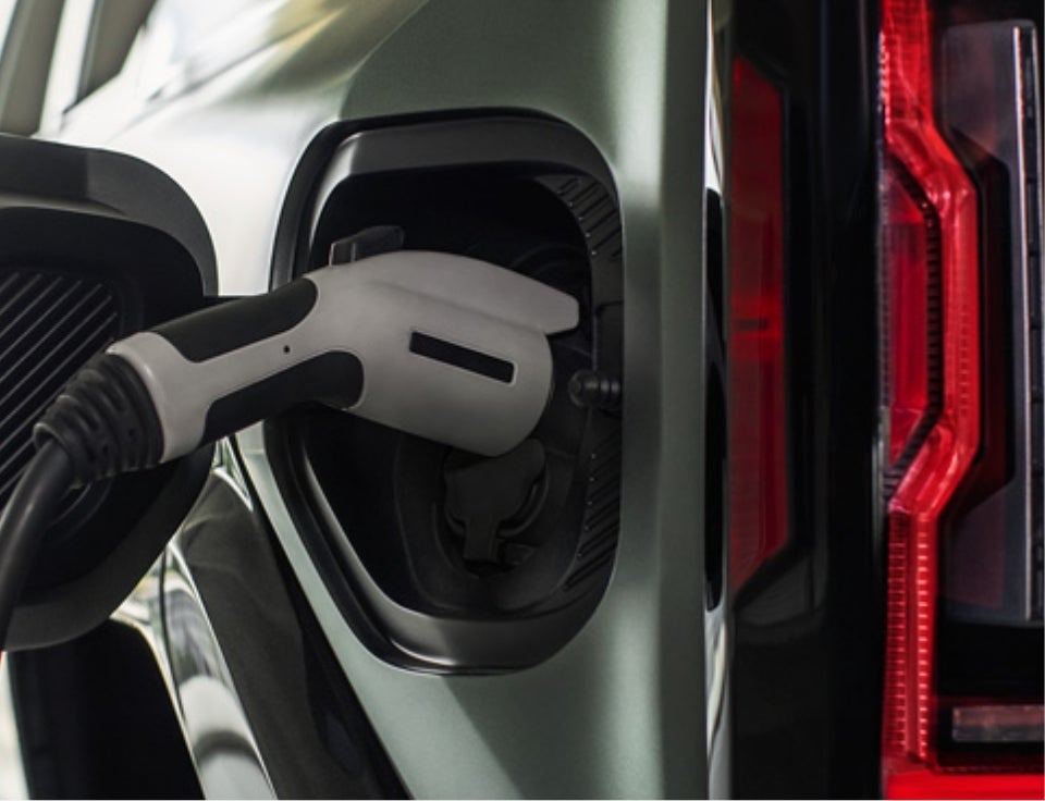 Close up of charging port with charger plugged in on a GMC Hummer EV SUV - Janzen GMC in ENID OK