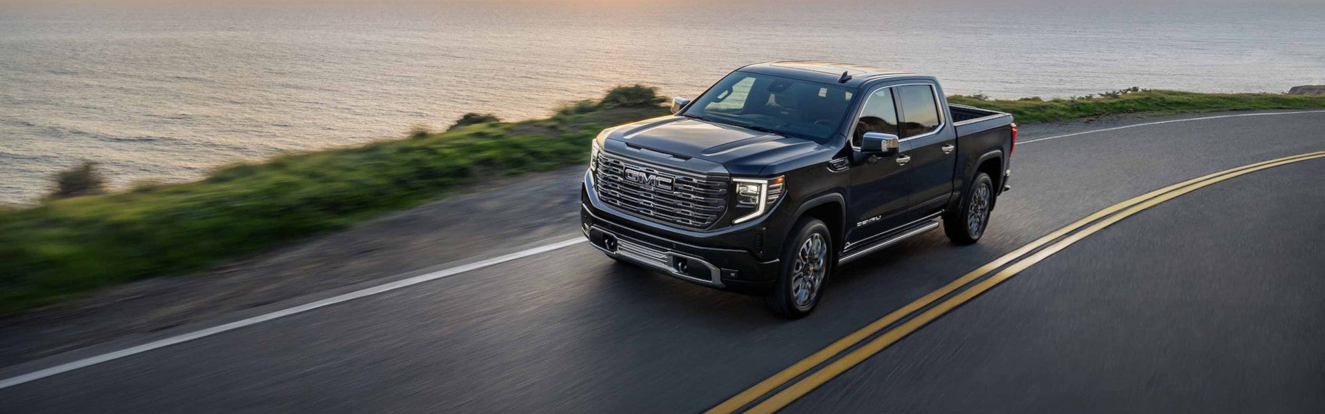Gray GMC Hummer running on road