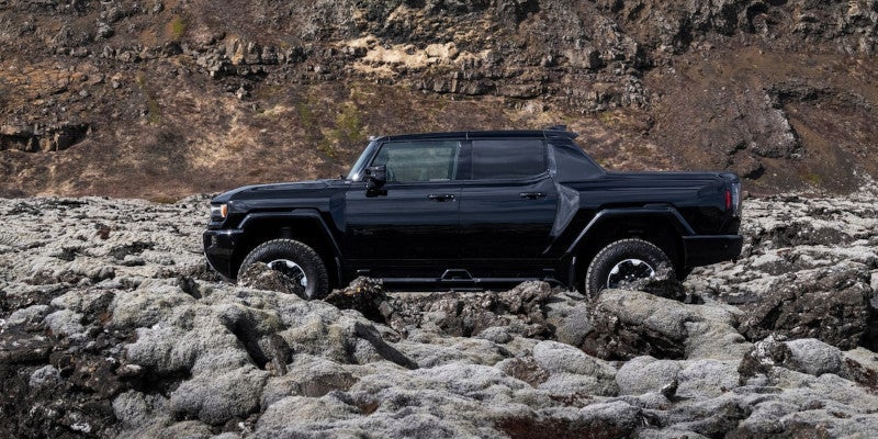 Black GMC Hummer ev pickup running offroading