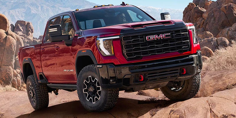 red gmc sierra running offroading in mountain area